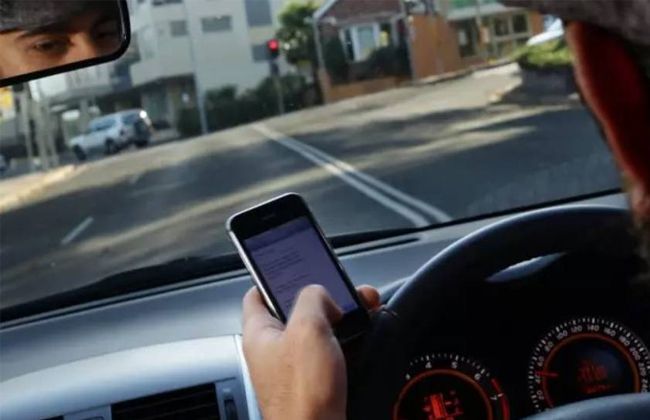 Using a mobile while driving in Queensland will cost you $1,000